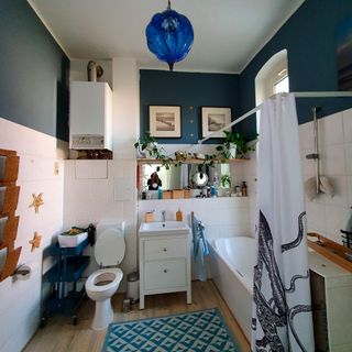 bathroom with wooden flooring and tub