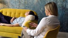 A stock photo of a woman lying on a psychiatrist&rsquo;s couch.
