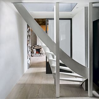stairway with white wall and door