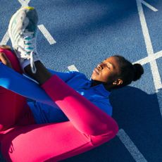 Best posture exercises: A woman stretching her legs on a track