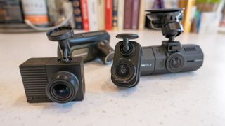 A group of dash cams on a marble table