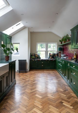 green galley kitchen with parquet flooring