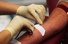 A woman donates blood