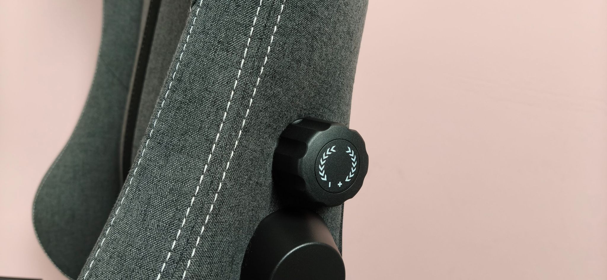 Close-up of lumbar dial on side of Boulies Master Rex (2026), against a pink background