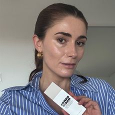 Eleanor trying the Jones Road SPF wearing a stripy blue shirt