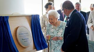 Queen Elizabeth II stands with Jonathan Jones, Chair of Trustees, after unveiling a plaque during a visit to officially open the new building at Thames Hospice