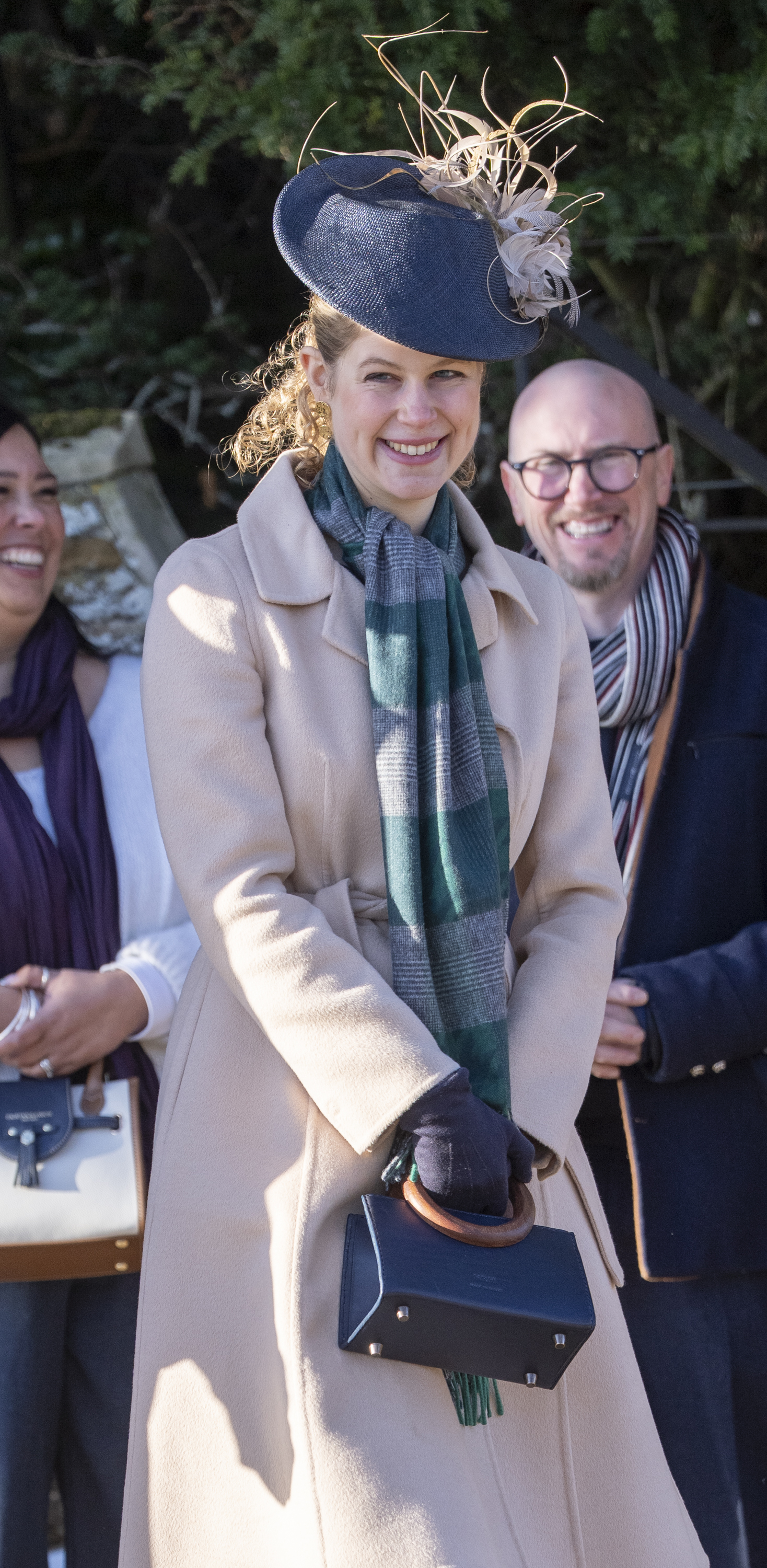 Lady Louise wearing a tan coat and plaid scarf on Christmas 2025