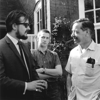 Yardbirds manager Giorgio Gomelsky with guitarist Eric Clapton and Lord Ted Willis in the peer's garden in England in 1964