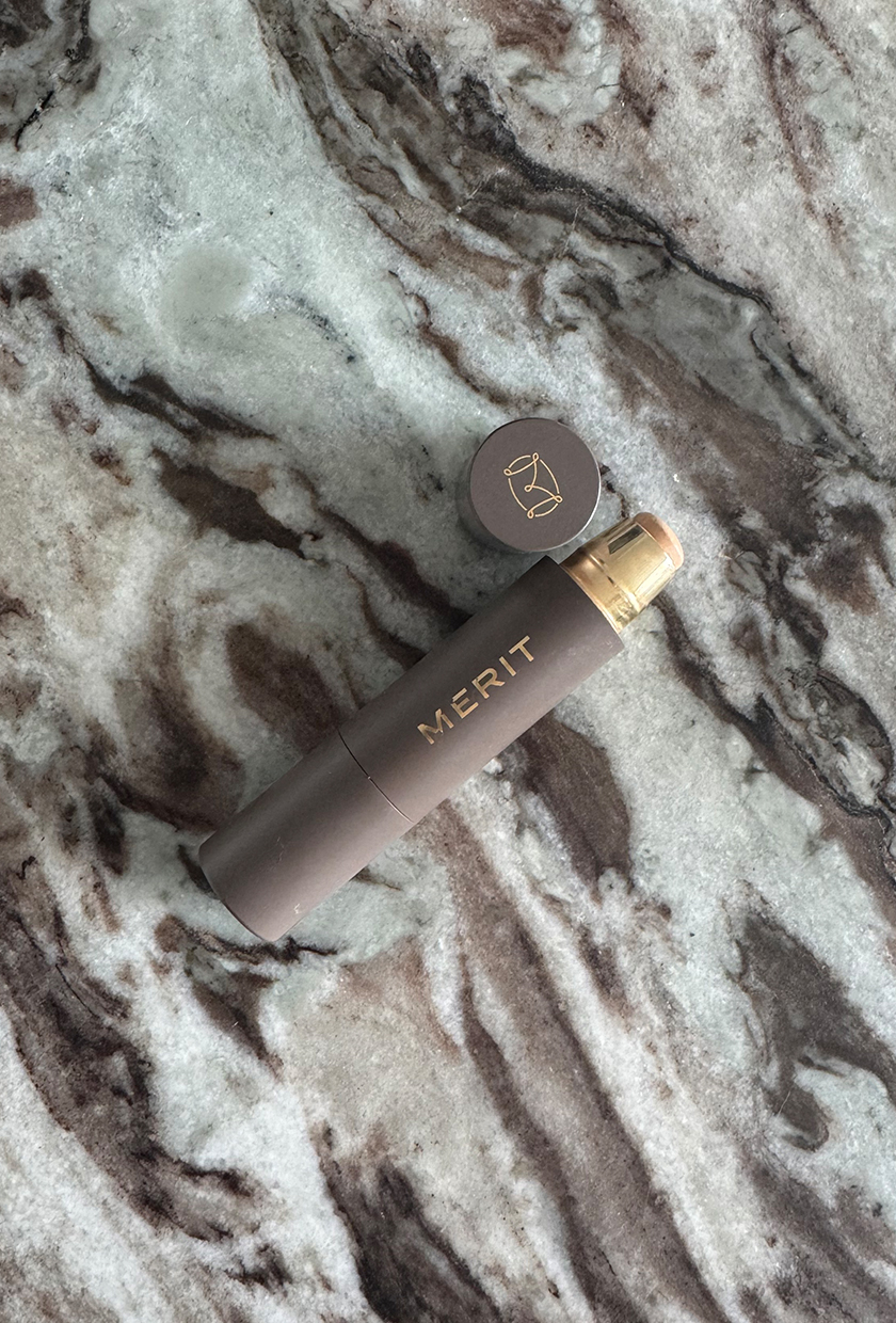 A photo of Merit Complexion Stick on a marble table