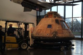 Columbia, the Apollo 11 command module, is moved into a closed gallery at the National Air and Space Museum so it can be prepared for its departure to the Steven F. Udvar-Hazy Center in Virginia.
