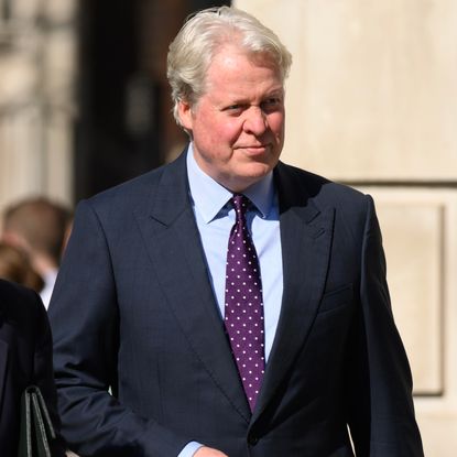 Charles Spencer wearing a navy suit and polka dot tie