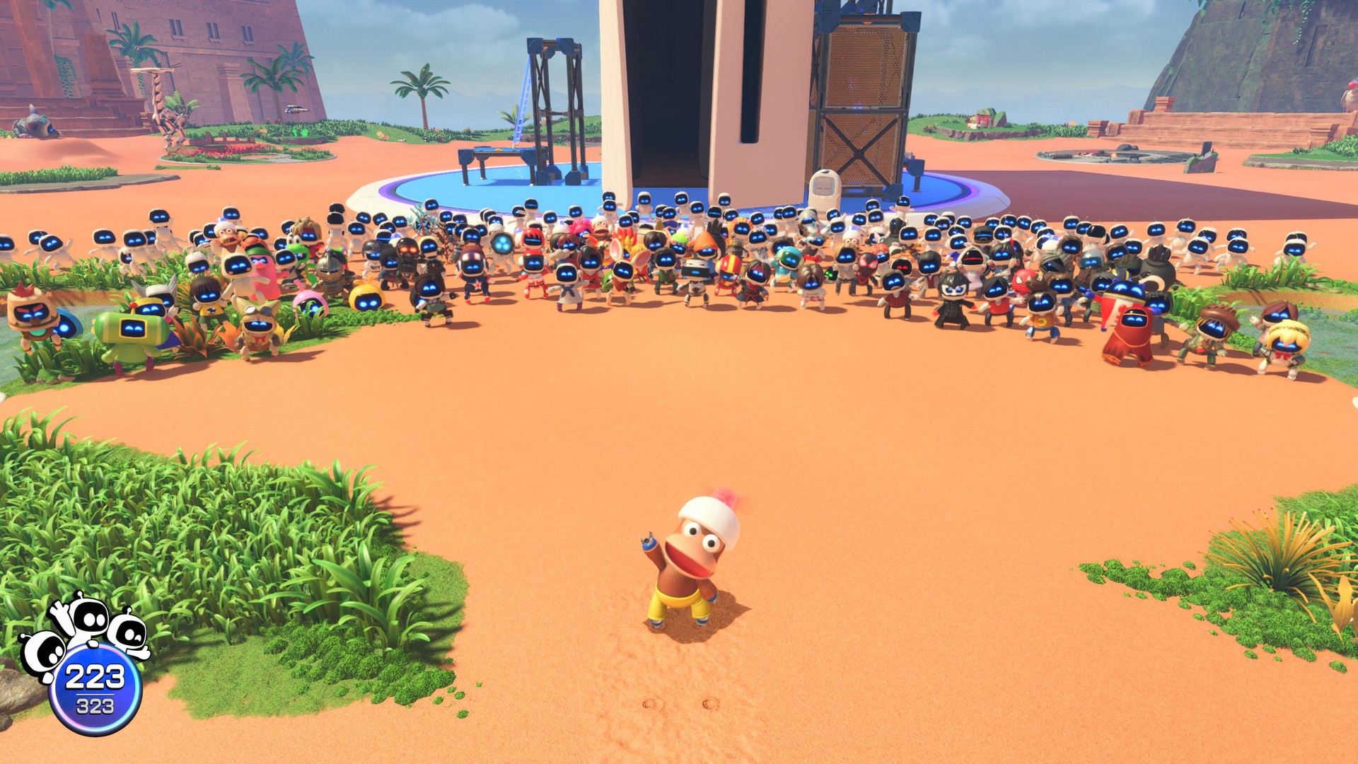 The Ape Escape Astro waves with the cast of bots behind him in Astro Bot