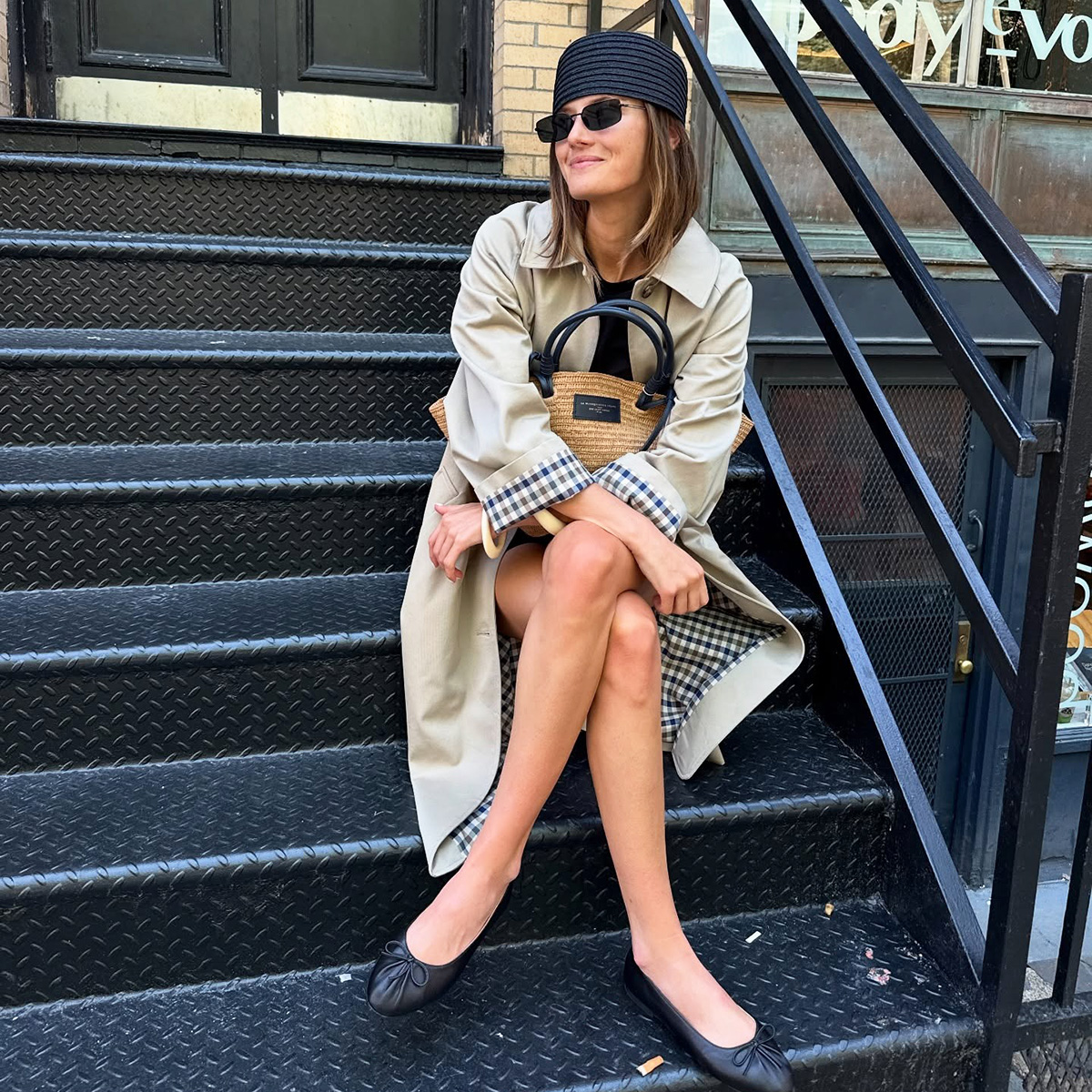 Coco Schiffer wearing a Sezane trench coat in NYC