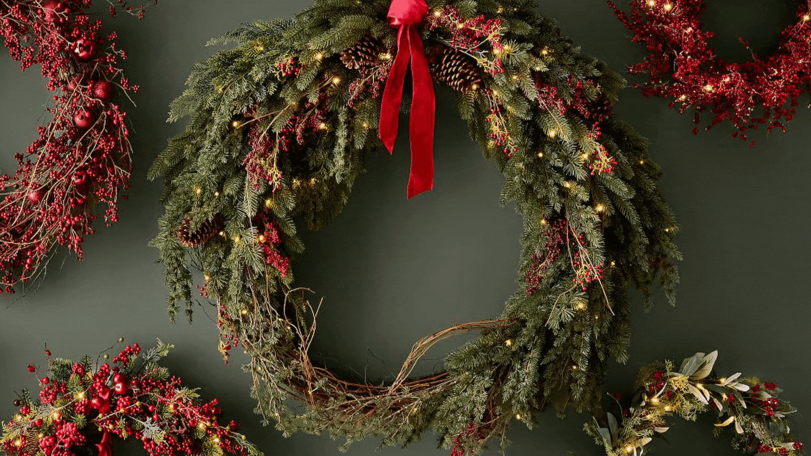 GIF of five rotating images of pre-lit Christmas wreaths.