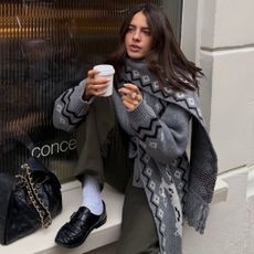 Woman wears grey cardigan, khaki trousers