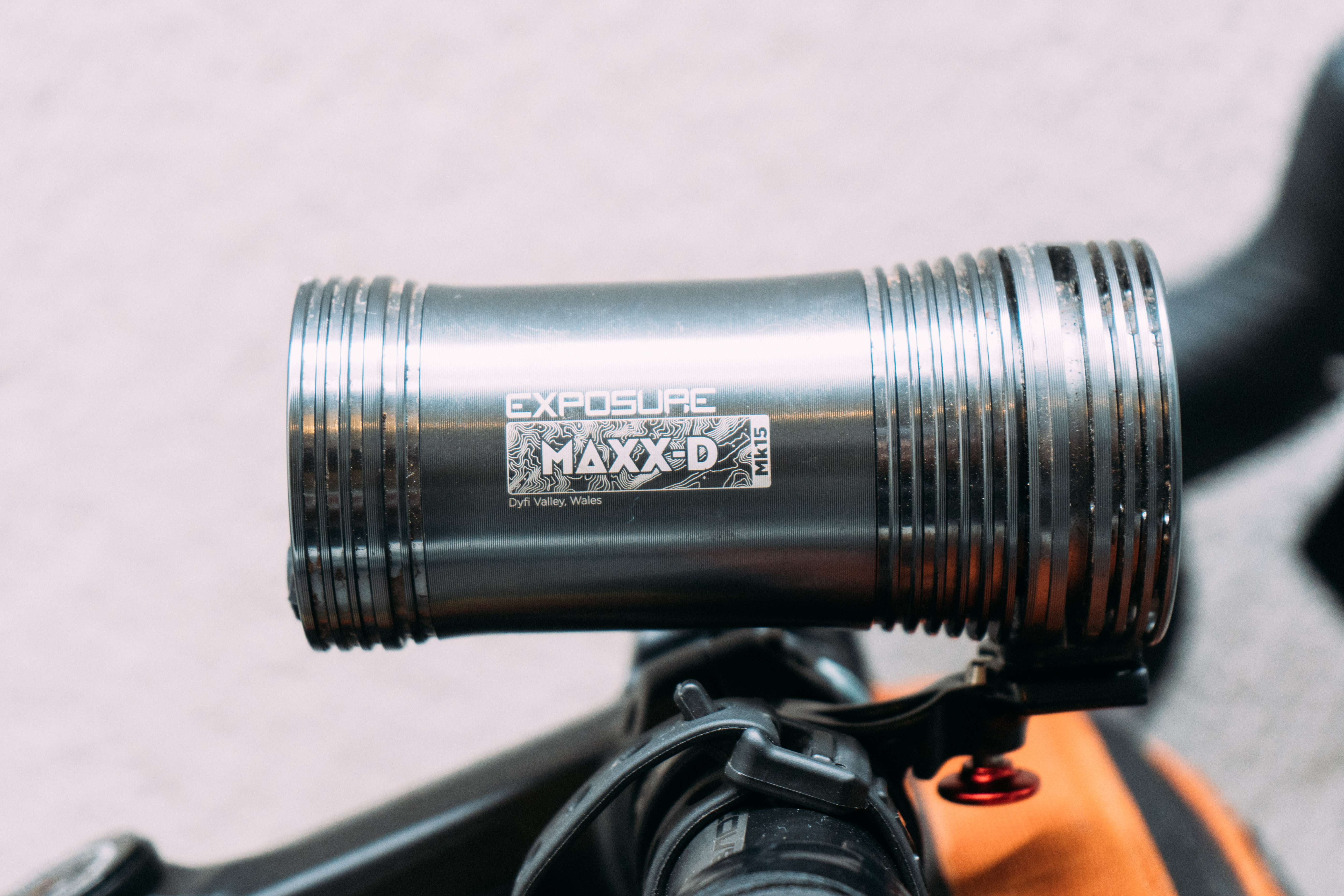 A side view of a large silver bike light machined from aluminium