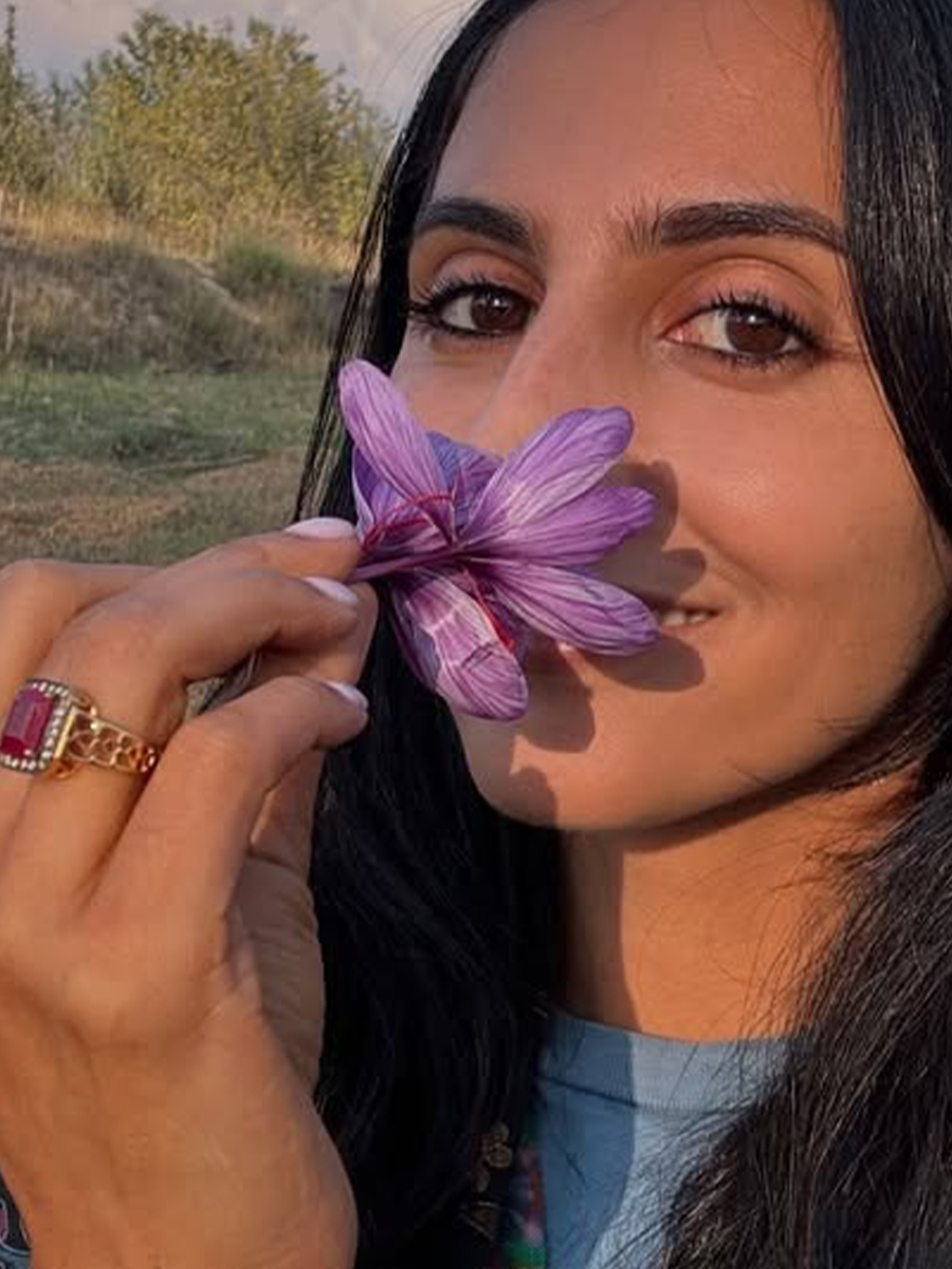Photo of Michelle Ranavat with a saffron plant