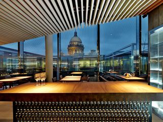 ﻿On the top floor, the glass walls of the U-shaped Mansarda restaurant frame the dome of St Isaac's Cathedral.