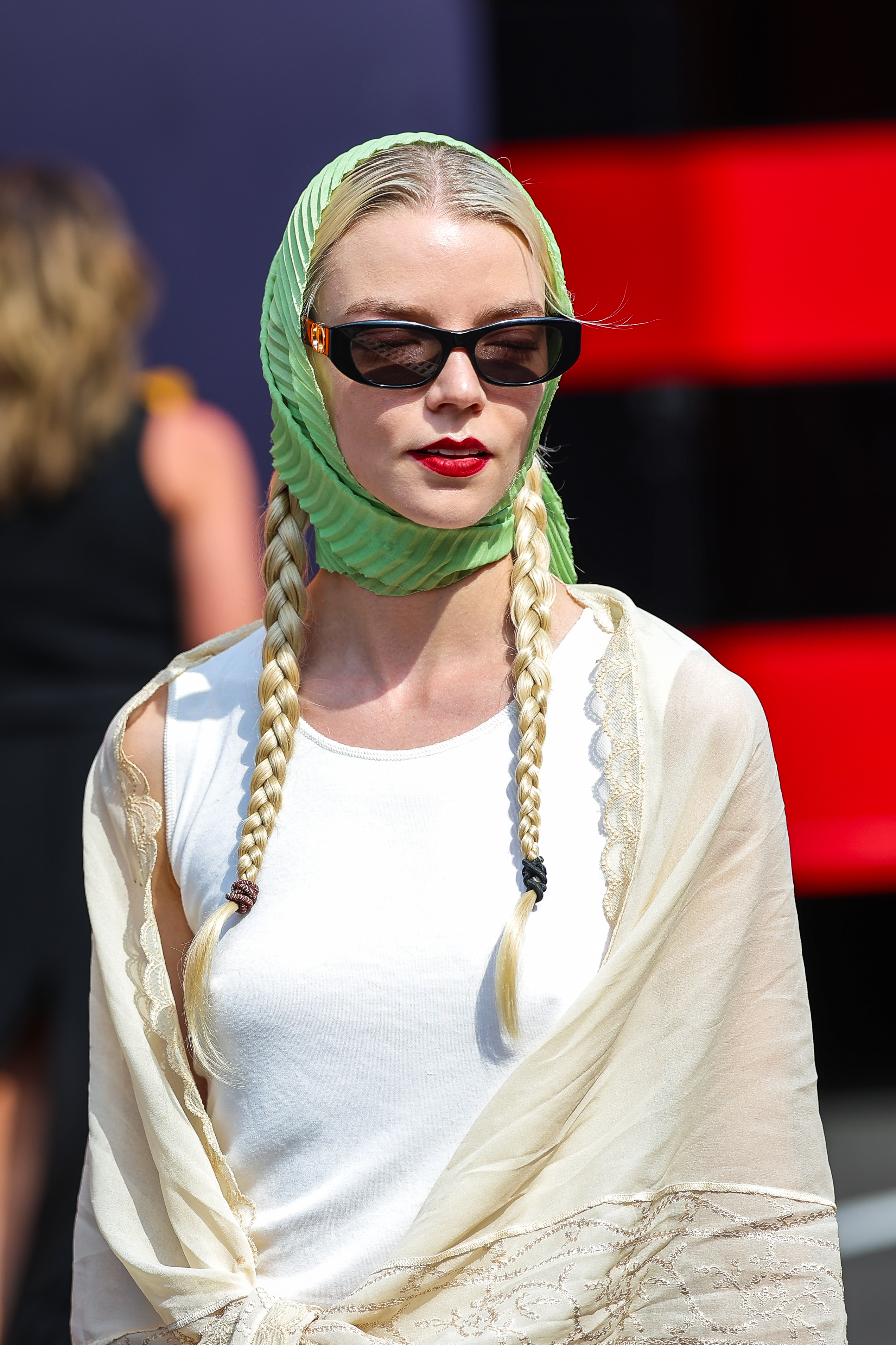 anya taylor joy wearing a green head scarf and black sunglasses