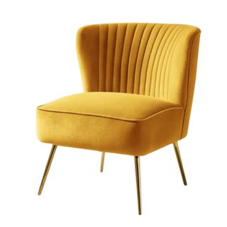 A yellow velvet chair with a striped back and gold legs