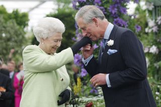 Queen Elizabeth II presents Prince Charles, Prince of Wales with the Royal Horticultural Society's Victoria Medal of Honour during a visit to the Chelsea Flower Show on May 18, 2009 in London.