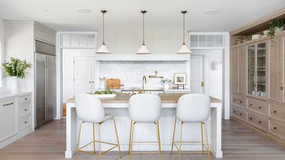 kitchen with white cabinets and bar stools and wooden floor