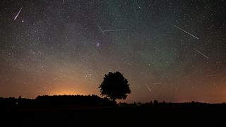 A photograph of a meteor shower in the night sky.