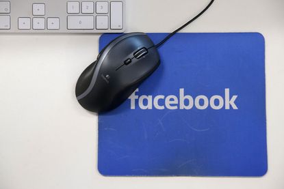 The Facebook logo on a mousepad