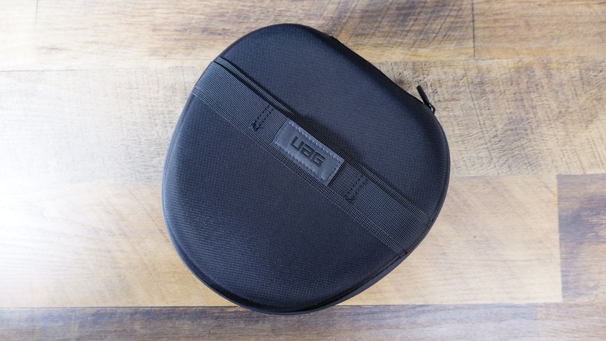 Urban Armor Gear (UAG) AirPods Max Case in black on a wooden floor