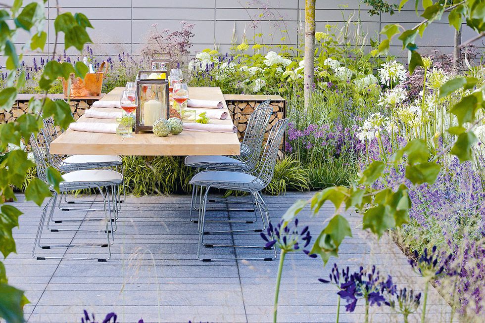 outdoor dining set in a small decked garden