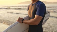 Athletic men wearing the Redmi Smart Band Pro for surfing