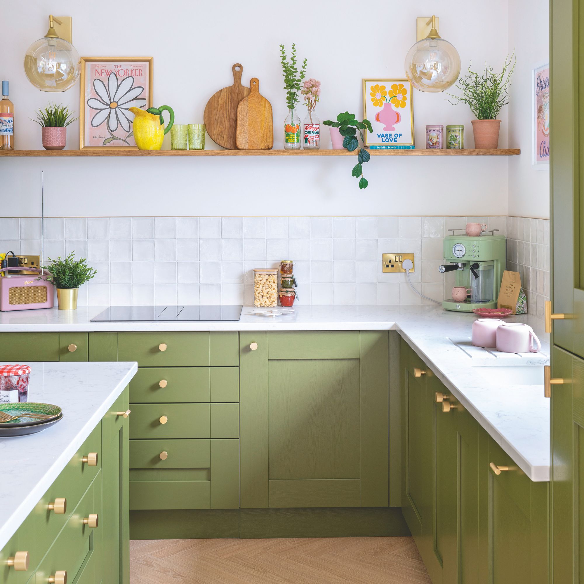 Kitchen with white walls and tiles and green cabinets