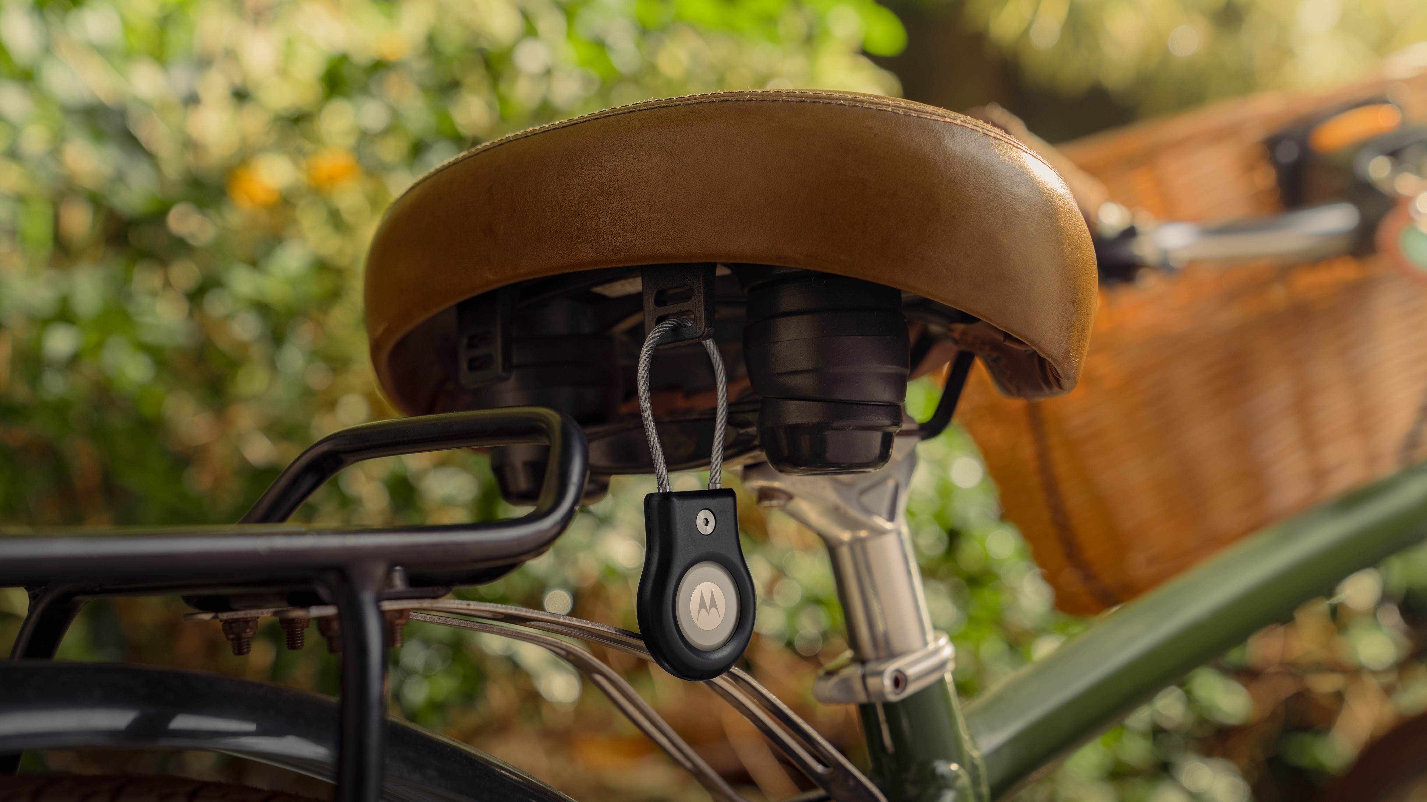 The Moto Tag 2 clipped onto the underside of a bicycle's seat.