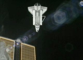 Atlantis After Undocking with ISS Solar Arrays in Foreground