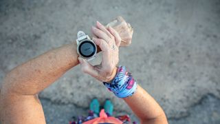 Woman looking at trail running programme on fitness tracker