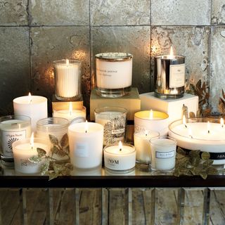 A collection of lit candles on tabletop