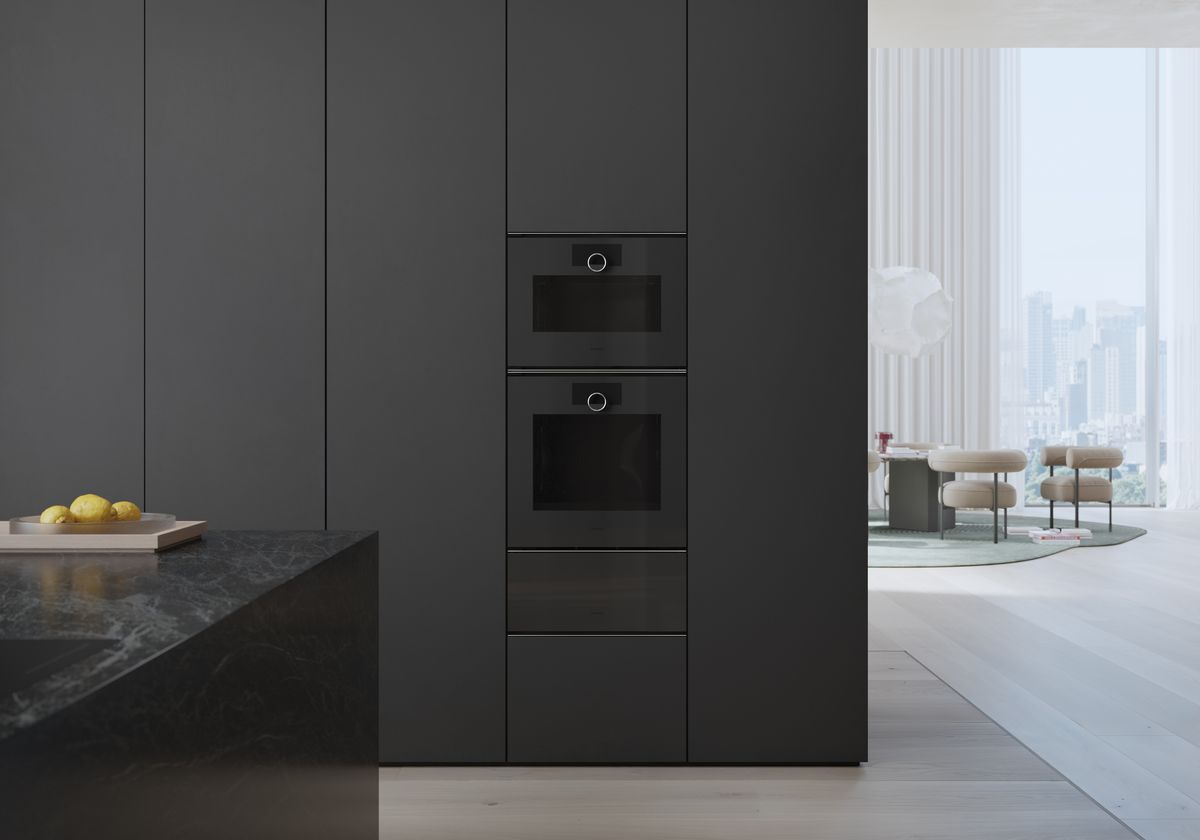 An all-black kitchen with a two in-built ovens