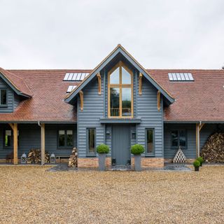 house exterior with blue wall red roof and glass window