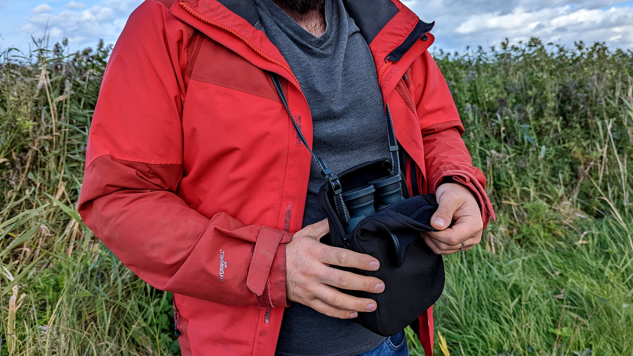 Binoculars around the neck of the author via neckstrap