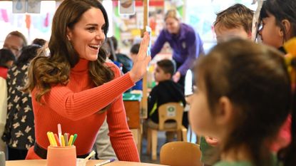 Britain's Catherine, Princess of Wales interacts with children making face masks during her visit to Foxcubs Nursery in Luton, north of London on January 18, 2023, as part of her ongoing work to elevate the importance of early childhood to lifelong outcomes. 