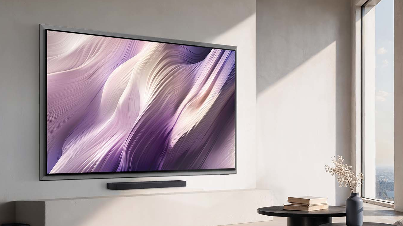 A wall-mounted Samsung S95H OLED TV displaying abstract, purple-colored imagery in a modern living room illuminated by sunlight
