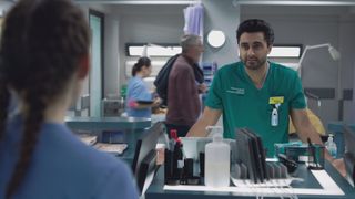 Tariq talks to Jodie in the reception area.