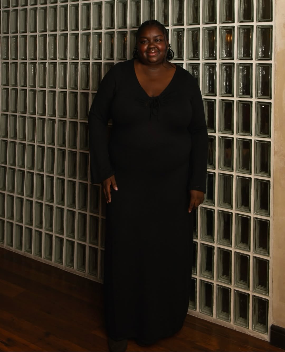 @abimarvel wears a black knitted maxi dress