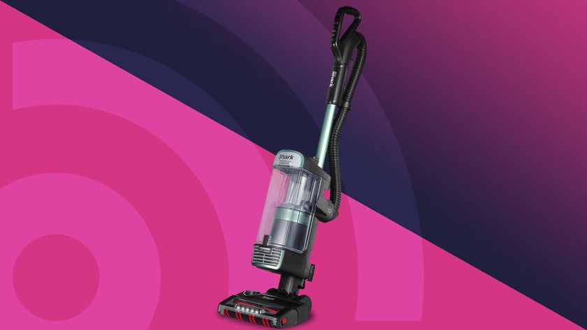 Shark Stratos upright vacuum cleaner against a magenta and blue background