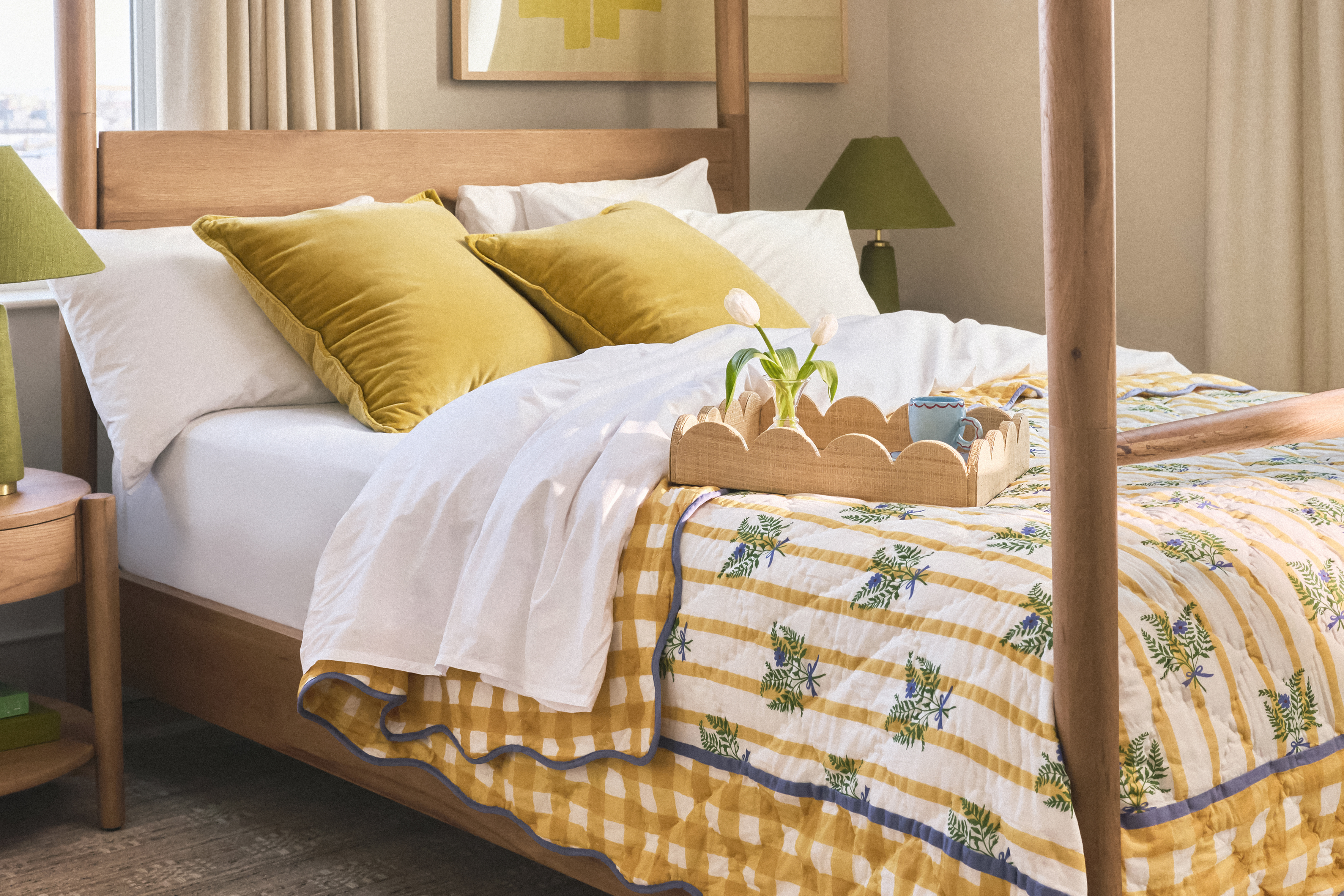 A hotel suite's interior, filled with patterned green, white, and yellow textiles, sculptural wooden and marble pieces, framed artworks in classical frames, and design-y board games.