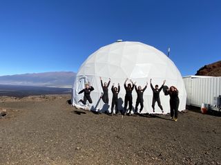 The Sensoria crew jumps for joy before entering the mock Martian habitat on Jan. 4, 2020. The crew will stay in the habitat until Jan. 18, 2020.