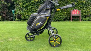 The excellent PowaKaddy Micra Push Cart, showing off its yellow and black colorway on the course