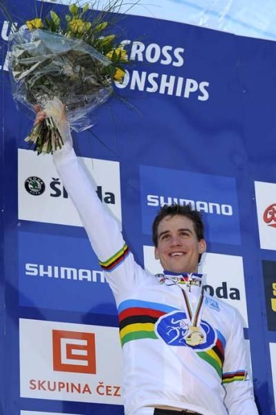Stybar hoists the winner's bouquet aloft.