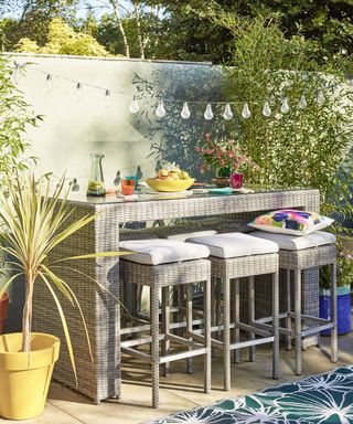 Gray table and bar stools seating area with tropical accessories