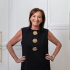 A picture of Jennifer Q. Williams - a woman wearing a black dress with brown hair smiling into the camera